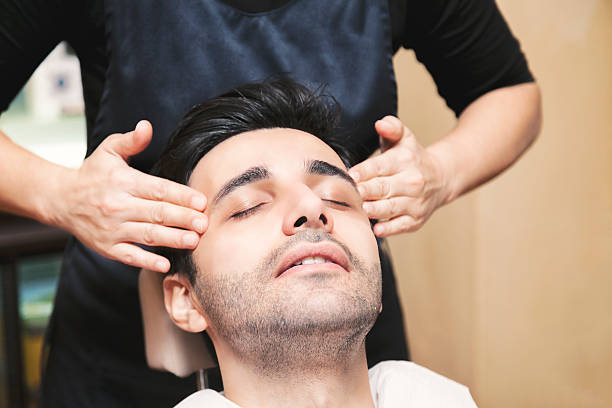 Young Turkish man getting skin care and facial massage - male beauty
